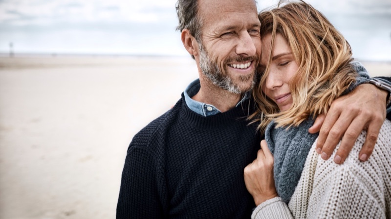 Man with arm around a woman