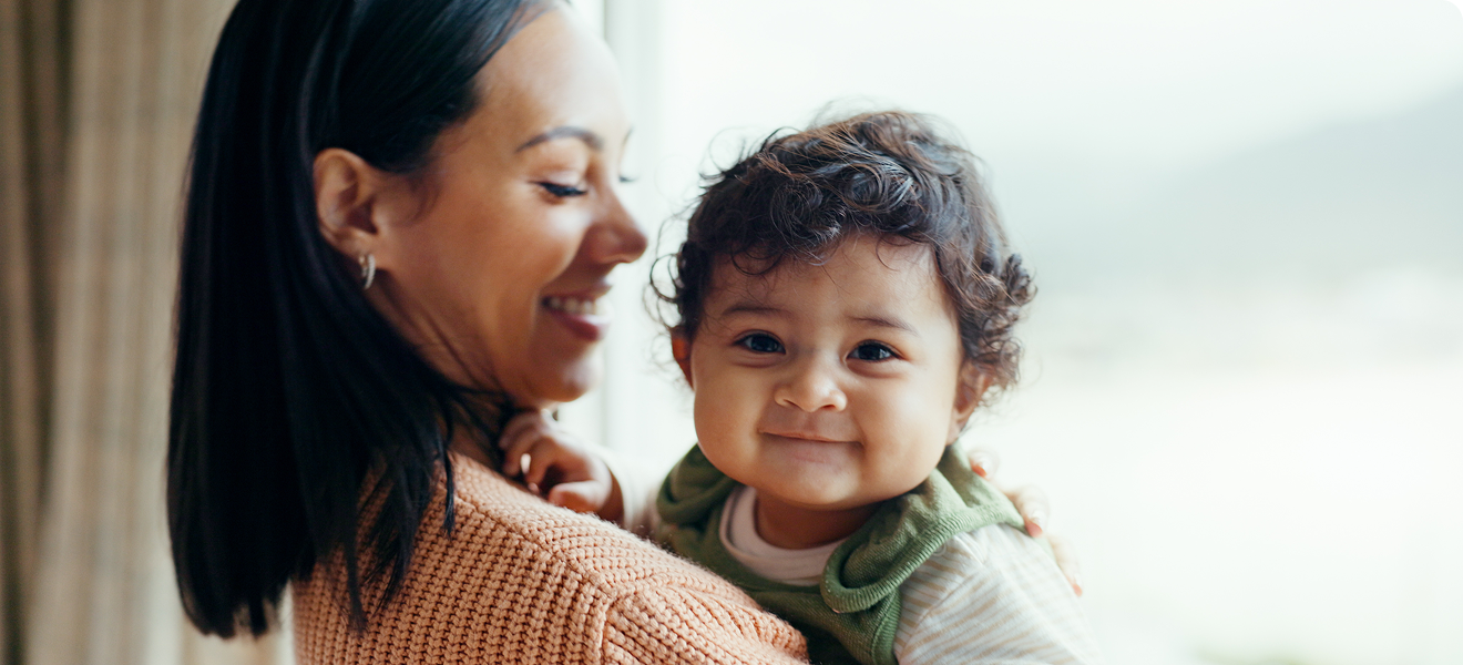 Mother holding a smiling baby
